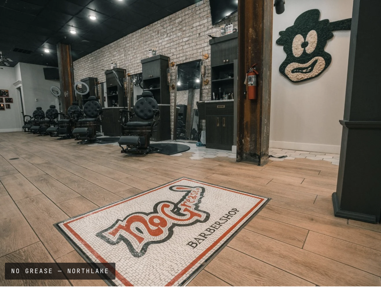 No Grease barbershop interior with floor mat and chairs